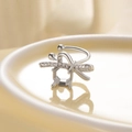 Silver bow ear cuff with clear cubic zirconia on a beige ceramic plate - Left Ear / Silver (Empty Mount)