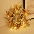 Golden Christmas wreath with pine cones and LED lights leaning on an elegant white table - 50cm (With Light)