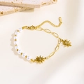 Detail of baroque pearl and gold stainless steel chain bracelet with sun pendants - Eight-pointed Star Pearl Style