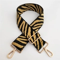 Close-up of zebra pattern wide strap with gold-tone metal lobster clasps and buckle - Black With Yellow Stripes