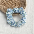 Floral scrunchie with blue flowers and green leaves on white pleated fabric - White with Blue Flowers