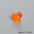 Detail shot of mini glitter resin duck figurine, 11x15mm miniature for landscape decor - Glow In The Dark Orange