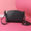 Black pebble grain PU leather crossbody bag with silver zipper and white stitching - Black