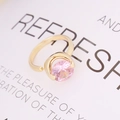 Close-up of a round pink zircon stone in a modern gold-plated adjustable ring setting - Adjustable Open / Pink