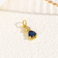 Macro shot of 18k gold turtle pendant featuring a heart-shaped blue gem and tiny diamonds - Blue (Humanoid Style)