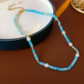 Baroque freshwater pearl necklace with blue beads and golden accents on a dark surface - Gold Blue Amazonite Pearl Necklace (#61)