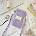 Lavender mesh phone bag with lanyard on desk, featuring breathable nylon and stylish patch - Light Purple
