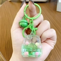Green schoolbag liquid keychain with colorful sand, green bell and spotted pendant - Mini Backpack - Green