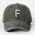 Detail of embroidered letter F on dark grey washed cotton baseball cap with retro texture - Letter F