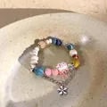 Detail of colorful beads with pink lucky cat ceramic pendant and silver flower charm - Multicolor Beads with Lucky Cat (23 Bracelet)