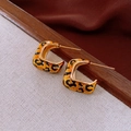 Detailed view of gold C-shaped hoop earrings with leopard print pattern and metallic finish - Gold C-Shaped Leopard Earrings