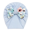 Close-up of light blue baby turban hat featuring a detailed floral print bow decoration - Light Blue