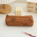 Detailed view of brown corduroy pencil case with smiley patterns in a cozy setting - Brown