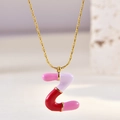 Detailed macro view of enamel letter Z pendant with pink purple and red mixed colors - Letter Z