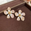 Macro view of flower stud earrings featuring white and pink enamel petals with gold finish - Gold-White-Pink