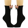 Detail von schwarzen Plüschsocken mit 3D Rentierpuppe und grüner Schleife für Weihnachten - Rentier mit Fliege / Schwarz
