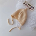 Infant ear-protection knit hat in cream beige with dual pom-poms and tie straps - Cap circumference 40-48cm, suitable for 3-18 months / Nipple Beige