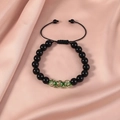 Detail of beaded adjustable bracelet with black glossy beads and gold foil glass charms - Green Gold Foil Texture / Obsidian Luminous Green