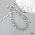 Dettaglio del laccetto per telefono in cristallo cangiante lungo 16cm e pesante 35g - Quadrato di Cristallo Verde