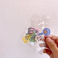 Hand holding a bag of mini hollow heart-shaped hair clips in candy macaron colors - Heart Shape (10Pcs)