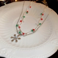 Close-up of a silver snowflake necklace with festive red, green and white beads - 49# Christmas Zircon Snowflake Beaded Necklace