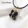 Handmade Merkaba lava stone necklace with golden wire wrap on white silk background - Lava Stone