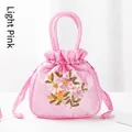 Light pink satin handbag with traditional floral embroidery and round handle - Light Pink