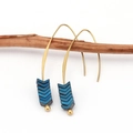 Detail of vintage gold ear hooks with stacked blue arrow charms on a wooden branch - Blue