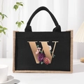 Black canvas tote bag featuring floral letter W print and contrast beige handles - Bronze Floral Letter W
