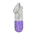 Macro detail of purple and silver rhinestone pill container with keychain metal hook - White + Purple
