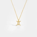 Detailed close-up of a gold Gemini pendant necklace with sparkling white zircons on white backdrop - Gemini