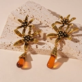 Detail of vintage gold flower earrings featuring amber resin water drop pendants - Gold / Gold