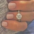 Classic silver engagement ring with cluster zircon setting worn on a woman's finger - US 9 / White Gold