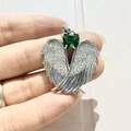 Detail of silver angel wing pendant with green heart gemstone and micro-pave crystals - Silver-Green