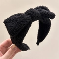 Chic black plush fabric headband featuring a large bow design for a trendy hair look - Black Bow Plush Style