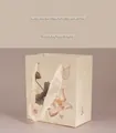 Elegant off-white Chinese-style jewelry gift bag with lotus pattern and silk handles - Lotus Pattern Gift Bag