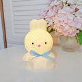 Cute bunny night light with blue plaid bow emitting warm glow in home setting - Coco Rabbit - Blue