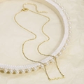 Detailed macro shot of golden Mama script necklace with adjustable extension chain - Gold (KN282197-KLX)