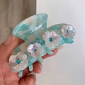 Light blue marbled hair claw clip featuring four white flowers with blue rhinestones - Fresh Sea Blue