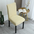 Beige waffle textured elastic chair cover protecting a minimalist dining room chair - General Specification / Beige