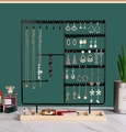 Detail of black metal jewelry organizer stand with rectangle wooden base on marble - Black