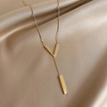 Minimalist V-shaped pendant necklace in gold finish on champagne silk fabric - Gold