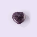 Polished heart-shaped natural amethyst stone with distinctive purple and white stripes - Purple Crystal