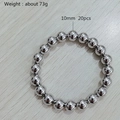 Elastic beaded bracelet with 20 pieces of 10mm silver metal balls on wood surface - Kb170842-z