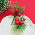 Close-up of artificial Christmas pine needles with bright red berries on a white ceramic plate - Green Pine Needle with 3 Red Berries