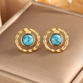 Macro shot of gold-plated twisted earrings featuring turquoise stone in Bohemian vintage style - Gold + Deep Blue Turquoise