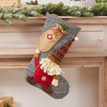 Knitted Christmas stocking with grey gnome doll and red hat hanging on mantel - Knit Santa Carrying Gift Stocking