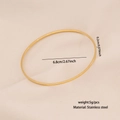 Top view of a thin golden stainless steel bangle with a diameter of 6.8cm on a textured surface - Gold Stainless Steel Bangle (1#)