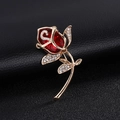 Elegant gold rose brooch with a large faceted red crystal and shimmering white rhinestones - Ruby Red Rose