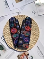 Black knit gloves with colorful spiral embroidery on a decorative woven mat - One Size / Red Blue Green Multicolor Jacquard